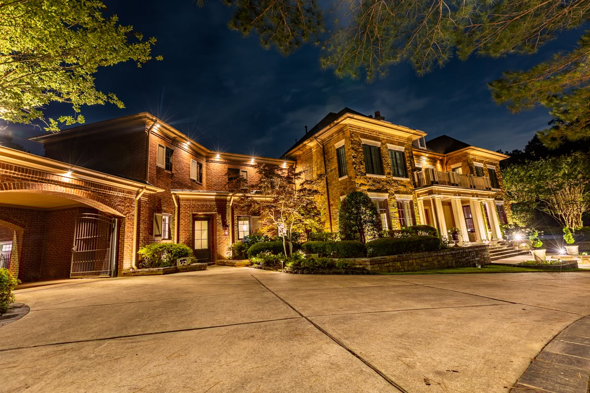Front of house with exterior lighting at night