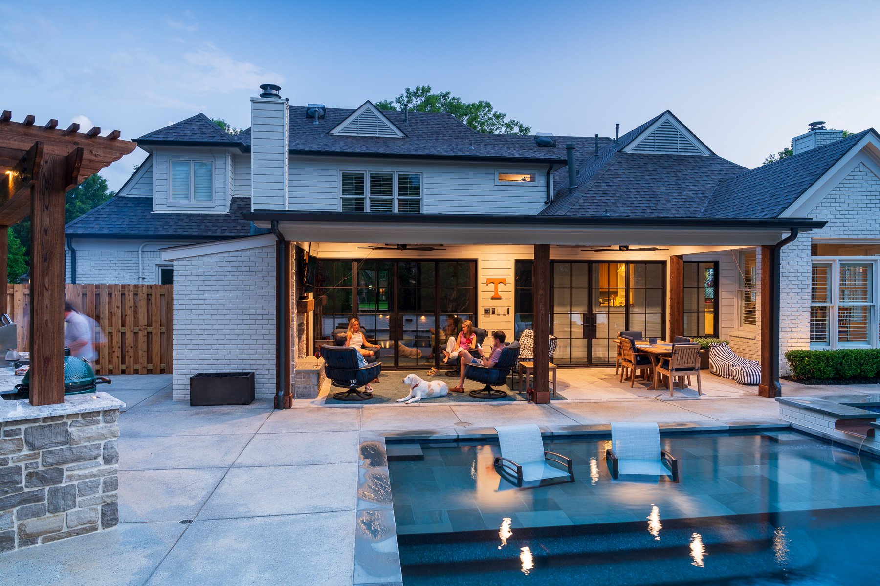 covered patio lighting pool reflection outdoor kitchen customers party