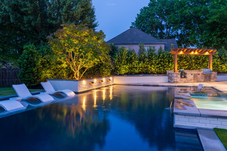 pool and patio with landscape lighting