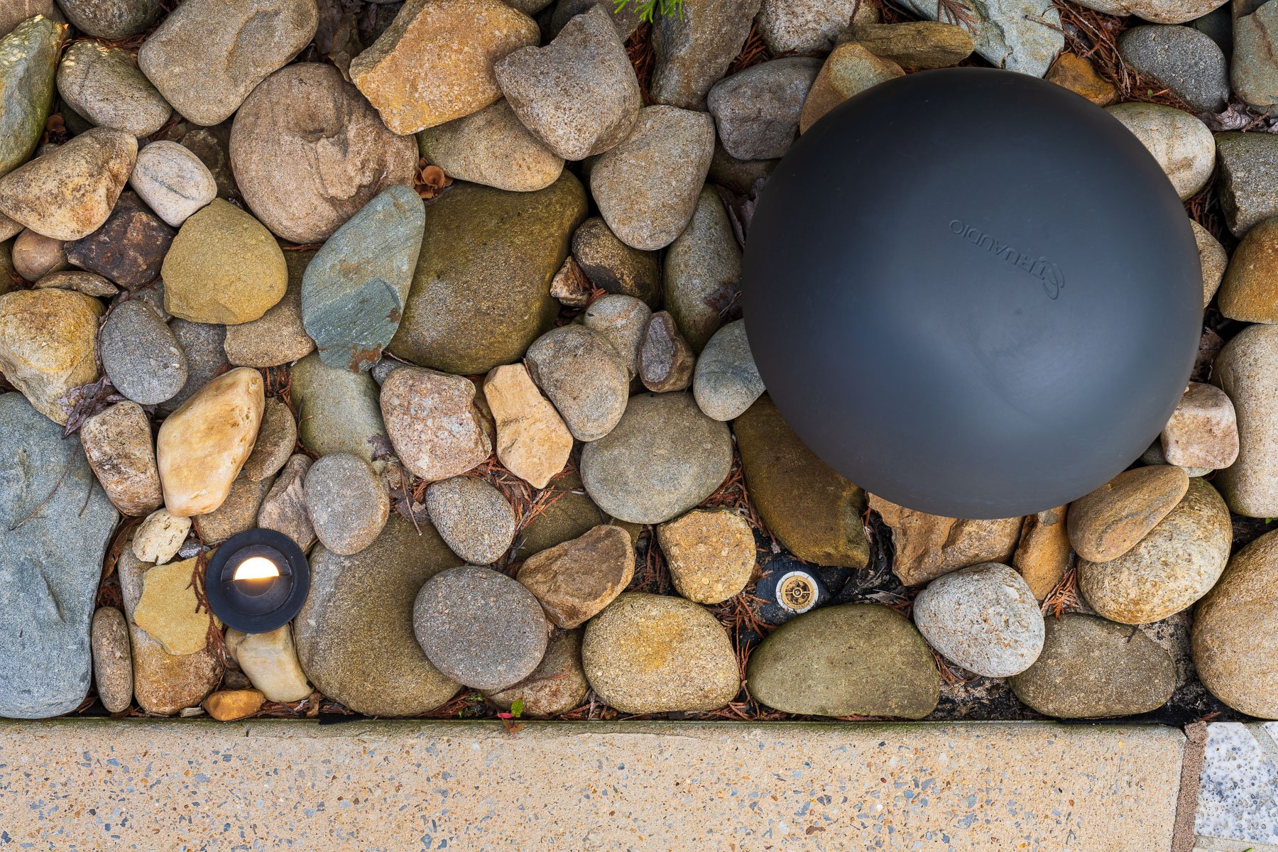top down detail audio speaker light gravel bed poolside