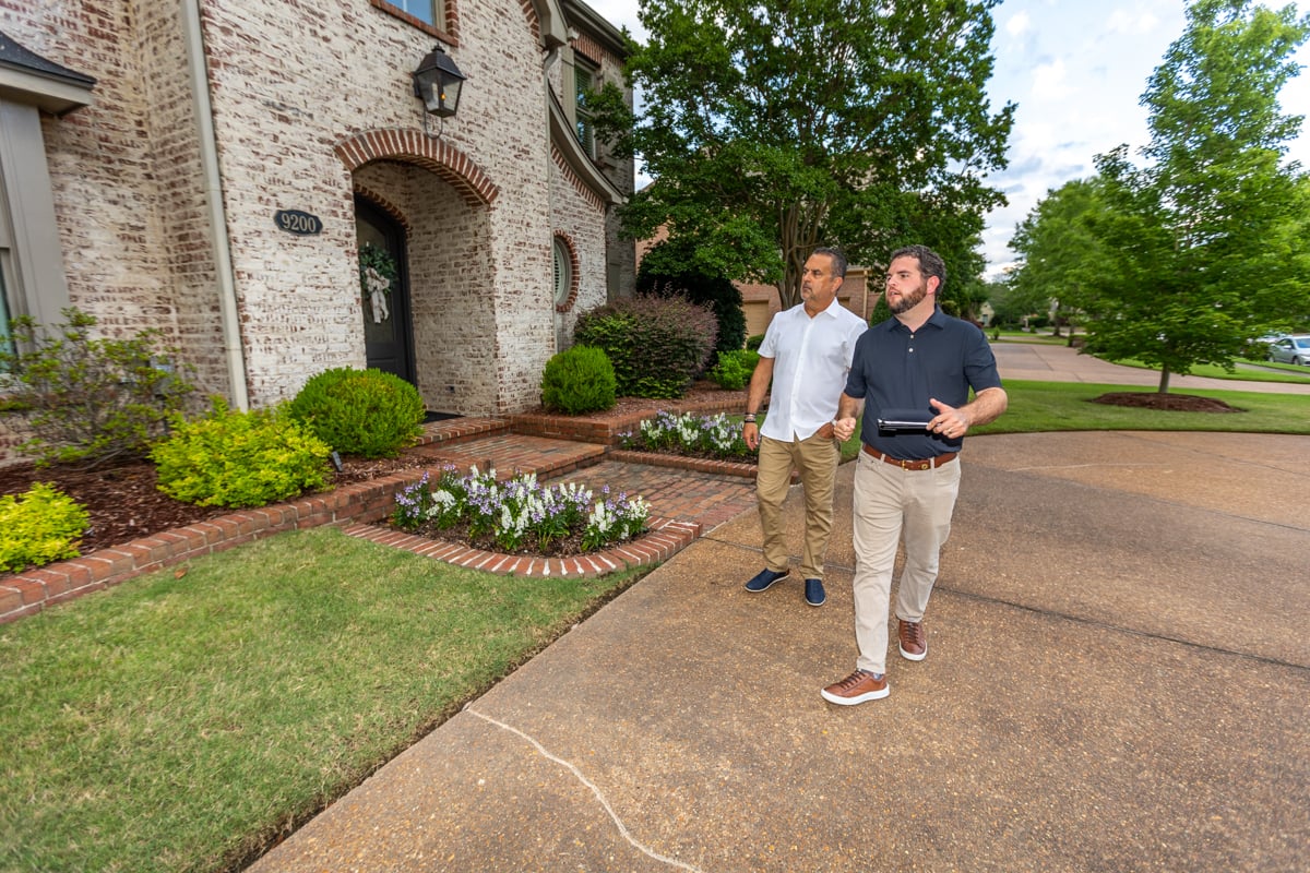 landscape lighting expert talking to customer on property 