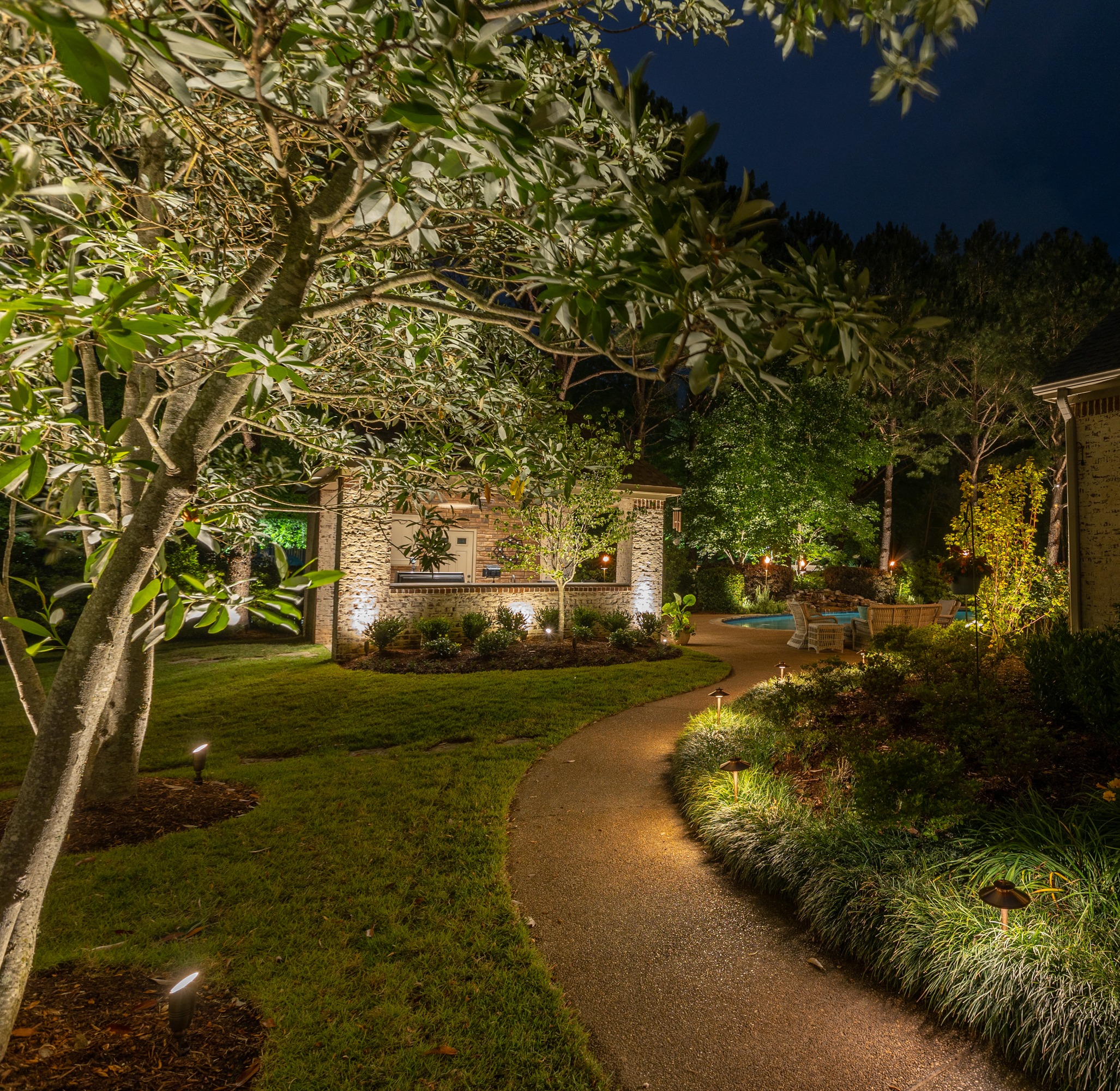Lighted up walkway in backyard