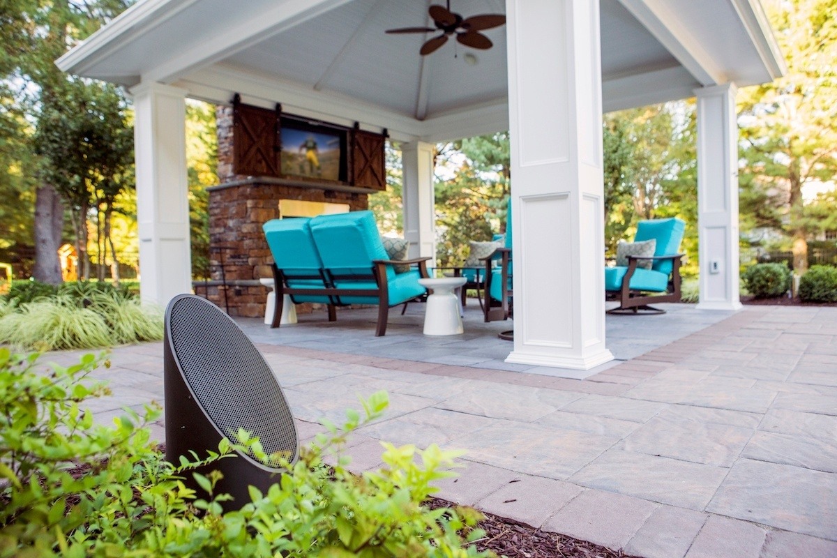 Outdoor audio speaker in landscape near back patio