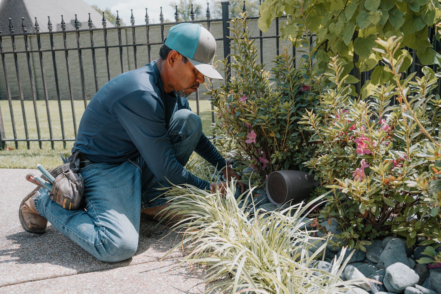 Outdoor audio speaker in landscape technician installation 1