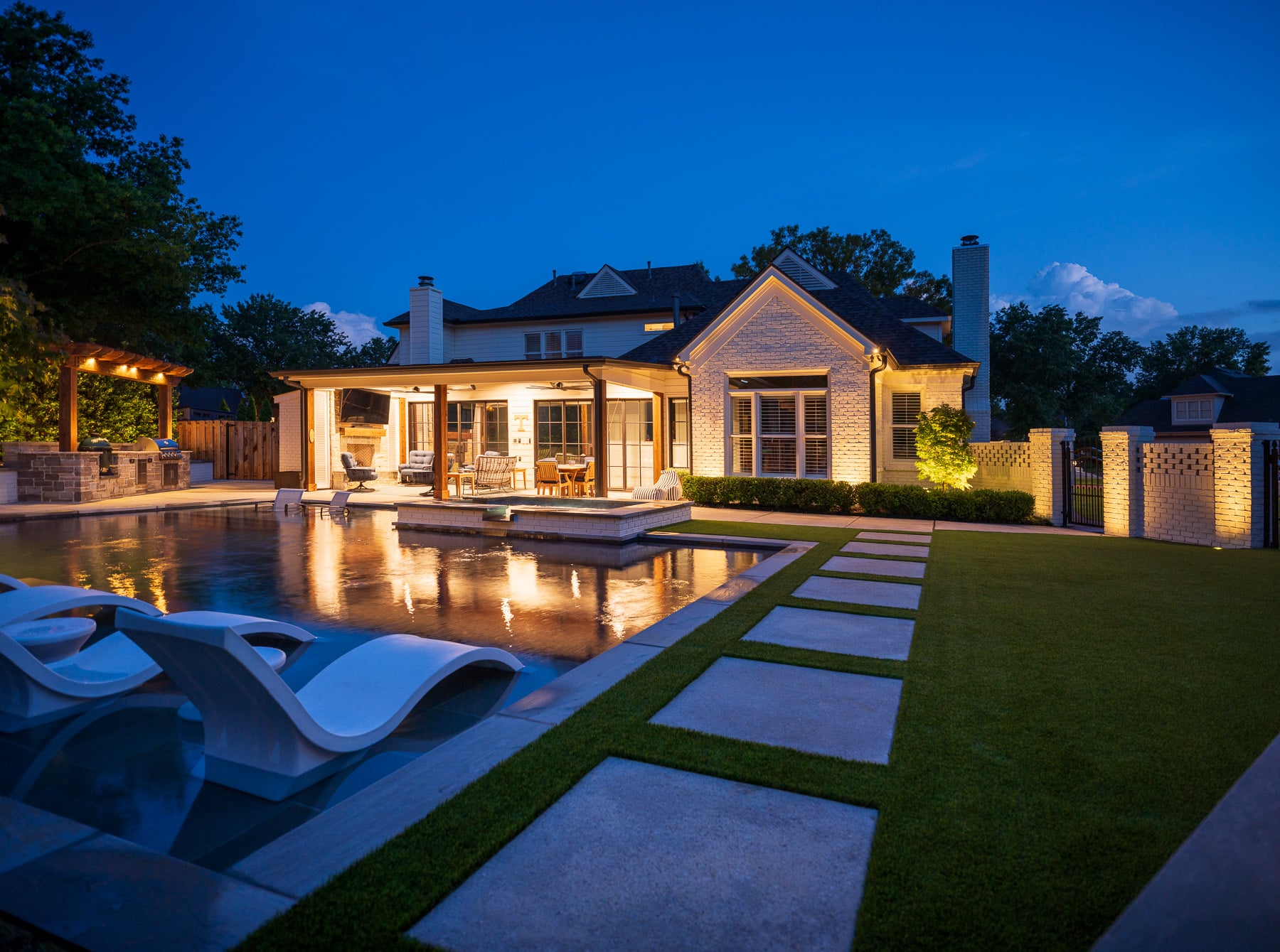 backyard with pool and patio pergola landscape lighting